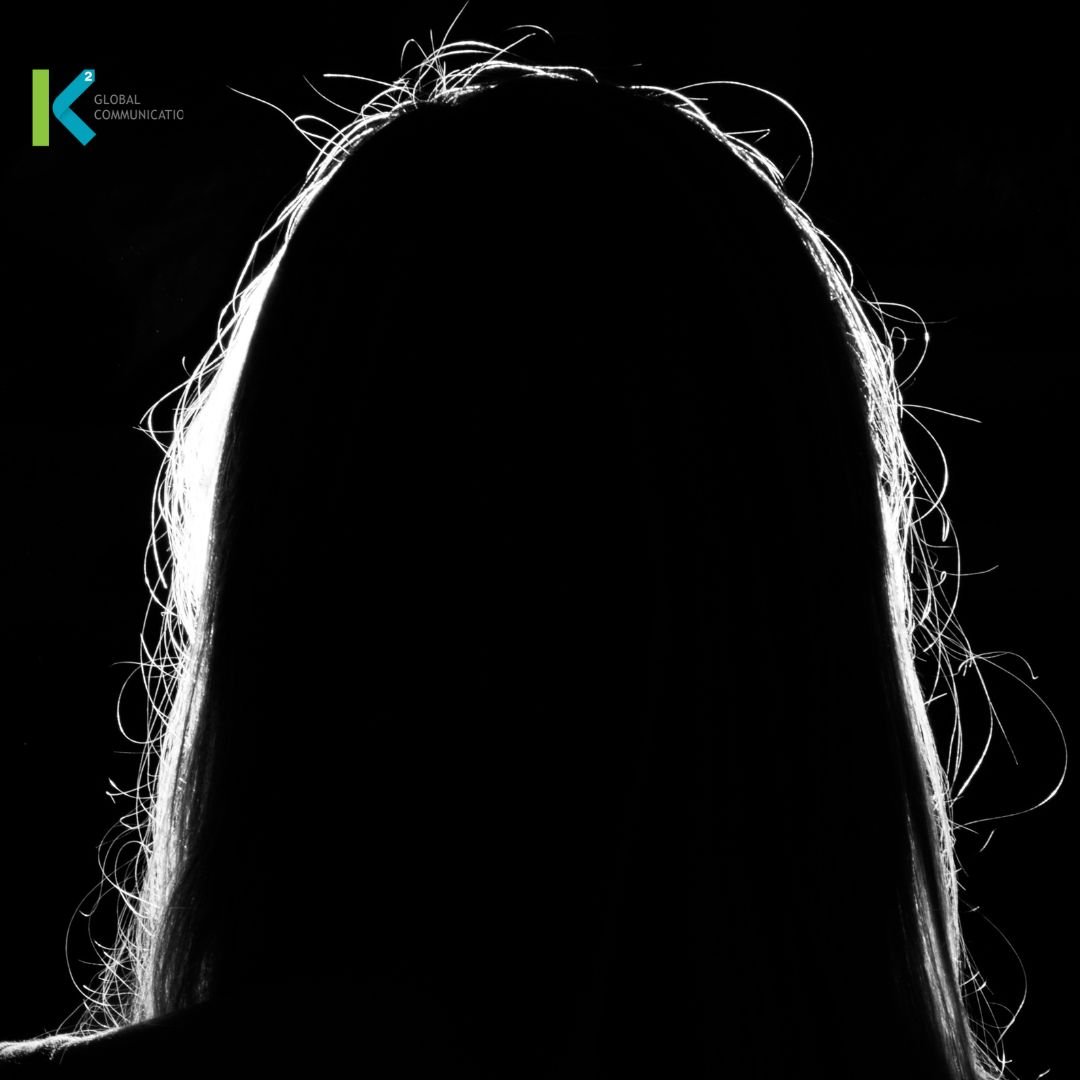 A dark picture with the outline of a girl with straight hair. 